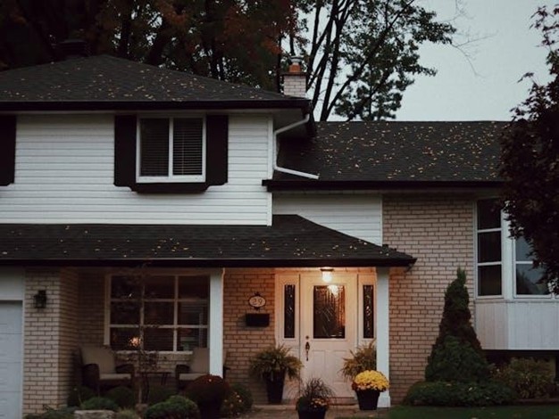 Front view of the exterior of a house with the porch light on